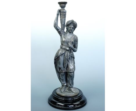 An early 20th Century spelter figural table lamp base, modelled as a woman in Moorish costume, on a glazed earthenware base, 