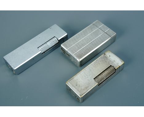 A vintage Dunhill and two Colibri cigarette lighters