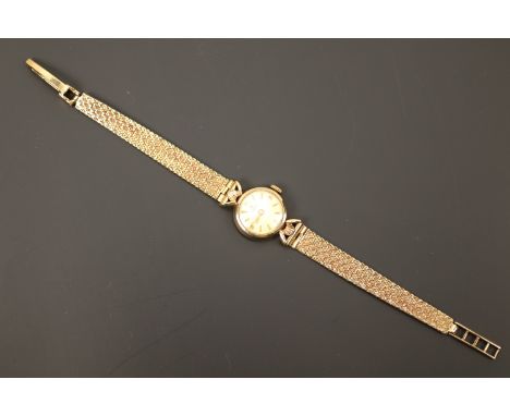 A lady's vintage 9ct gold cased Tissot wristlet watch on a 9ct gold bracelet strap, having a champagne face and dagger and Ar
