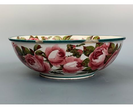 A Wemyss Ware wash bowl or basin, decorated with pink cabbage roses to the interior and exterior, 40 cm (a/f, broken and repa
