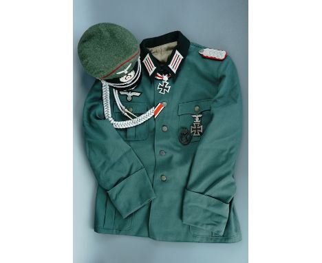 A group of replica Second World War German army uniforms, headgear, awards and boots