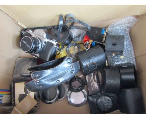 A Miranda SLR camera with various accessories and a boxed tripod and monopod