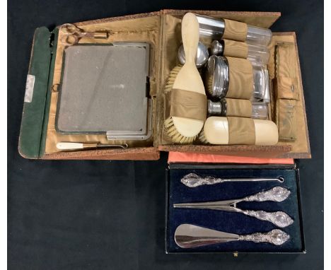 A George V silver hafted three piece dressing set, including button hook, glove stretchers and shoe horn, Chester 1913, boxed