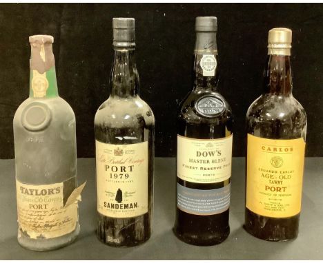 A bottle of Taylor's 20 year old tawny Port, 1985; a bottle of Sandeman Port, 1979; a bottle of Carlos age-old tawny Port; a 