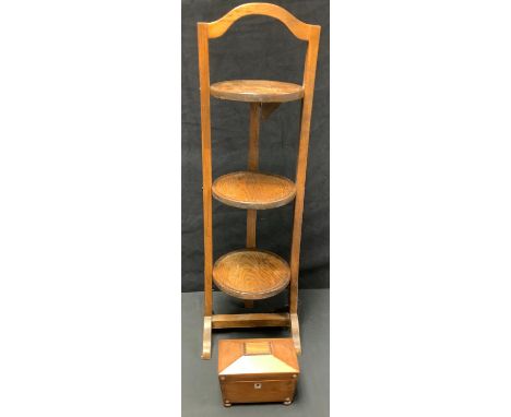 A Victorian sarcophagus shaped tea caddy, mother-of-pearl inlaid, four bun feet; an oak three tier folding cake stand (2) 