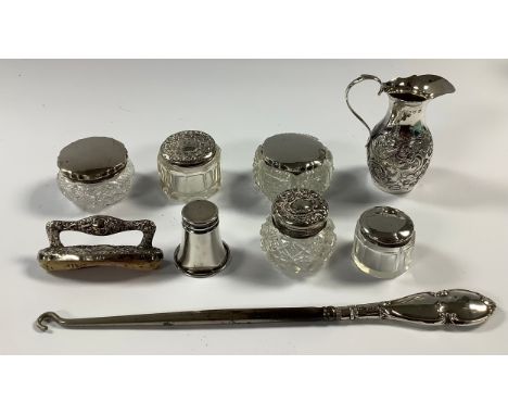A Victorian silver slender baluster jug, embossed with foliate scrolls, 8.5cm, Chester 1898, 43.8g; a silver hafted nail buff