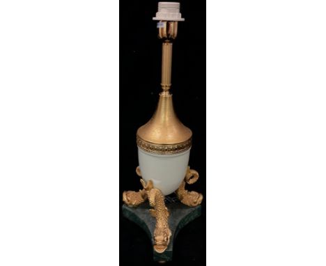 A gilt metal urnular table lamp, raised on three dolphins, marble base, three ball feet, 54cm high over fitting 