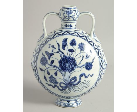 A CHINESE BLUE AND WHITE PORCELAIN TWIN HANDLED MOON FLASK, painted with central floral spray, the base with four-character m