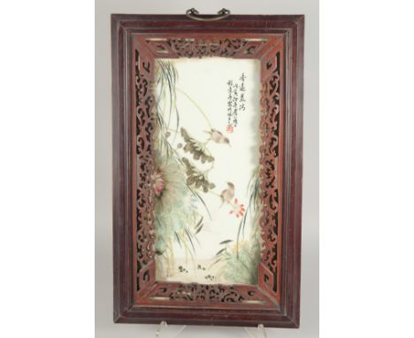 A CHINESE REPUBLIC PERIOD FAMILLE VERTE PORCELAIN PANEL, encased in a hardwood frame, the panel painted with birds and lotus,