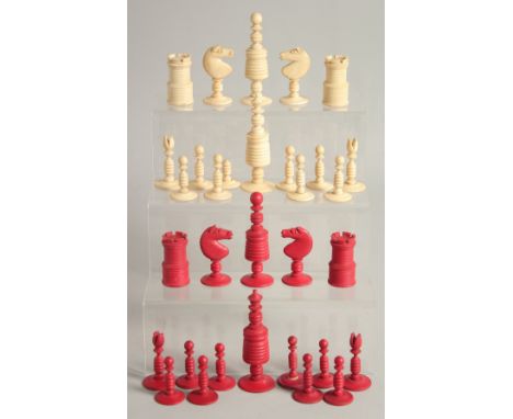 A COLLECTION OF CARVED AND STAINED BONE CHESS PIECES.