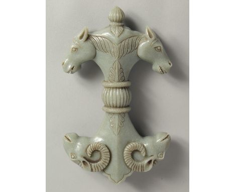 A LARGE MUGHAL STYLE CARVED JADE SWORD / DAGGER HANDLE, carved to one end with double-headed horse, the other with double-hea