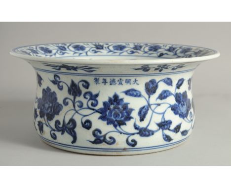 A LARGE CHINESE MING STYLE BLUE AND WHITE PORCELAIN BASIN, decorated all over with large flower heads and scrolling vine, the