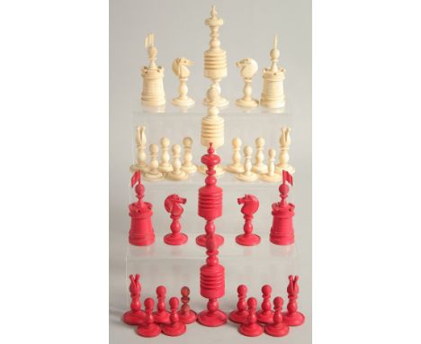 A COLLECTION OF CARVED AND STAINED BONE CHESS PIECES.