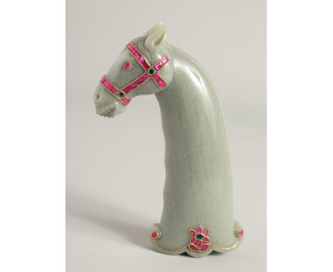 A MUGHAL STYLE CARVED JADE HORSE FORM DAGGER HANDLE, onlaid with decorative wire work and semi-precious stones, 15cm long.