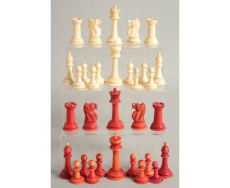 A COLLECTION OF CARVED AND STAINED BONE CHESS PIECES.