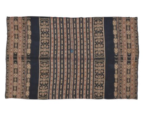 A cotton textile, Indonesia, 20th century, woven in dark blue, cream, red and lighter blue, with a design of stripes and oval