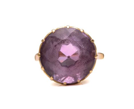 An amethyst dress ring, comprising a round mixed-cut amethyst of size 14.8 mm, mounted in coronet setting to a tapered D-sect