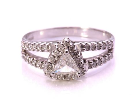 A trillion-cut diamond cluster ring in 18ct white gold, centrally set with a triangular diamond of 5.5 x 5.5 x 2.2 mm, surrou