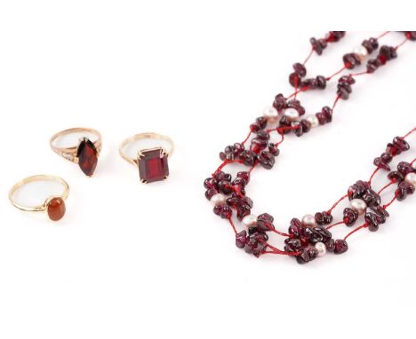Three gem-set rings and a bead necklace; consisting of a ring set with oval red jadeite cabochon, measuring 8.8 x 5.9 mm, col