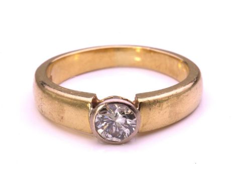 A diamond solitaire ring in 18ct gold, comprising a circular-cut diamond of 5.0 x 5.0 x 3.5 mm, collet set in a white gold lo