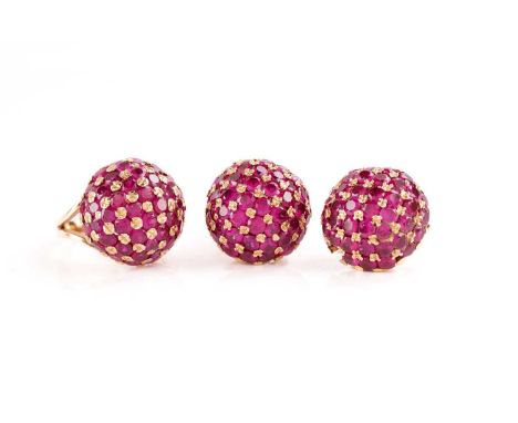 A yellow metal and synthetic ruby bombe style cocktail ring, set with round-cut stones, approximately 1.75 cm diameter, unmar