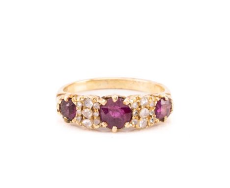 A late Victorian ruby and diamond half-hoop ring; the three graduated circular cut rubies set between, seven stone rose diamo