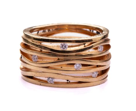 Omega - A seven-row ring set with diamonds in 18ct yellow gold, of undulating design, tension-set with six brilliant-cut diam