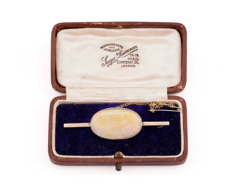 A 9ct yellow gold and opal bar brooch, bezel-set with a large flat opal, showing orange and green play of colour, opal measur