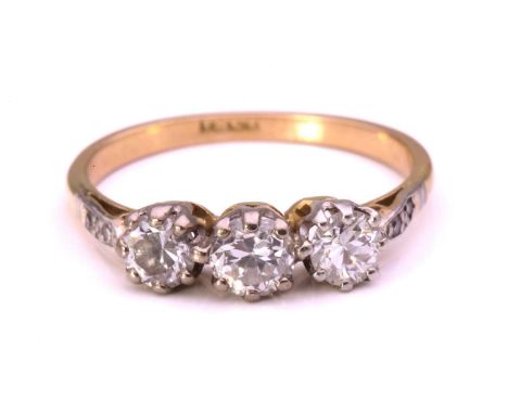 A diamond trilogy ring, set with three old-European cut diamonds, and four single-cut diamonds on the shoulders, to a D-secti
