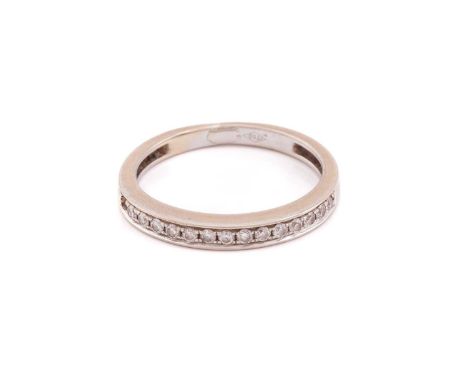 A diamond half-eternity ring, comprising a row of circular-cut diamonds of 1.4 mm in pavé setting, to a tapering flat shank, 