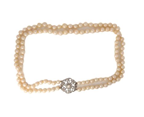 A double-strand pearl necklace with a diamond-set clasp, comprising two strands of hand-knotted pearls, graduated from 8.3 mm