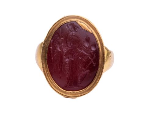 A Roman carnelian intaglio ring, centrally set with an oval carnelian intaglio in a closed-back rub over setting, depicting a