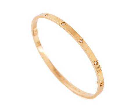 Cartier - A diamond-set 'LOVE' bangle in 18ct yellow gold, slim model, set with ten brilliant-cut diamonds, supplied with a s