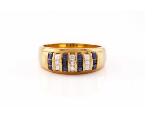 A diamond and sapphire dress ring of stripe design, alternating channel-set rows of table-cut sapphires and diamonds, to a ta