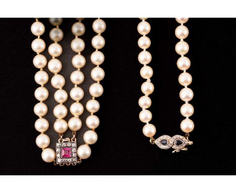 Two cultured pearl necklaces with gem-set clasps; the first consists of a strand of cream-coloured round pearls of 6.7 mm wit