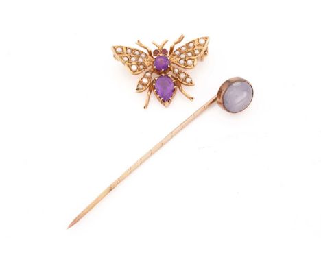 An amethyst and seed pearl butterfly brooch set in rose gold. with amethysts to the head and thorax and half pearls to the wi