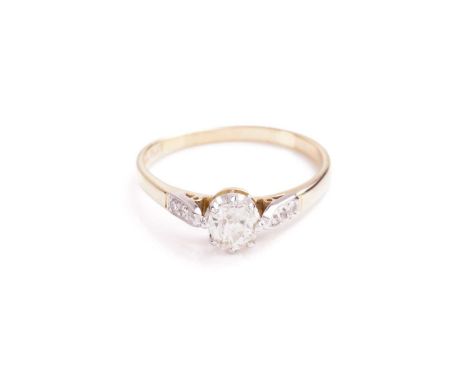 A single stone diamond ring; the old cushion cut diamond in eight claw mount to three stone set diamond shoulders and later 1