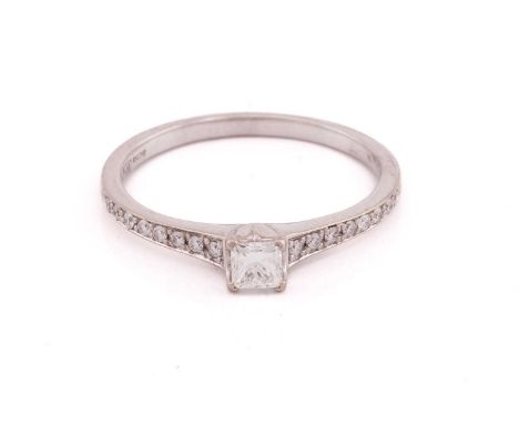 A single stone diamond ring; the round brilliant cut diamond in four claw setting to a plain 18 carat gold shank. Ring size K