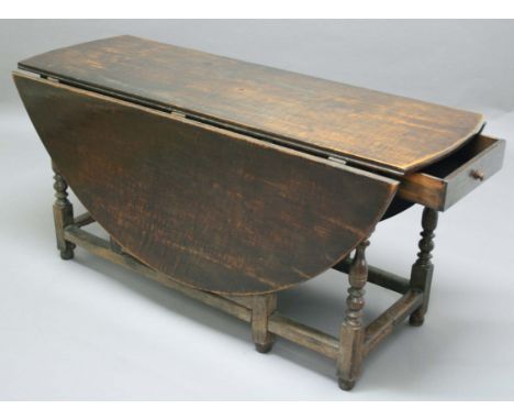 OAK GATELEG DINING TABLE, 18th century, the oval top above a single drawer, on block and turned legs with block stretchers, 1