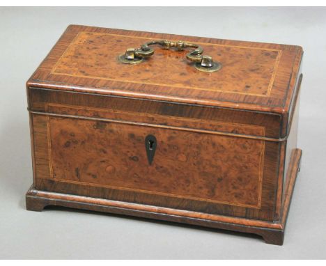 REGENCY BURR YEW AND INLAID TEA CADDY, of rectangular form, with crossbanding and line inlay, gilt brass swing handle, the fi