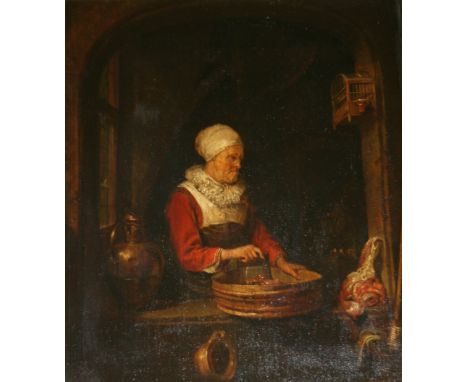 AFTER GERRIT DOU (1613-1675) A KITCHEN MAID CHOPPING MEAT Oil on panel 34.5 x 29cm. ++ Old, fine vertical crack through figur