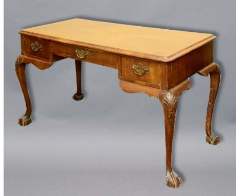 GEORGE II STYLE WALNUT WRITING TABLE, probably late 18th century, the geometric top with feather banding above three drawers,