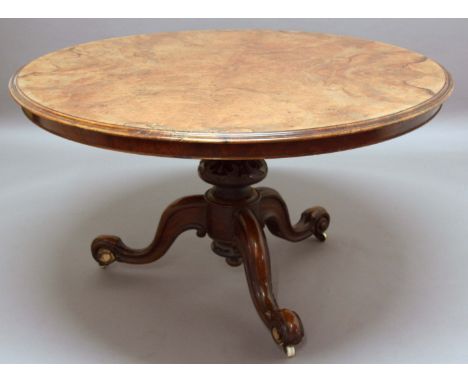 VICTORIAN WALNUT TILT TOP BREAKFAST TABLE, the circular top on a turned column with stylised carving and scrolling tripod bas