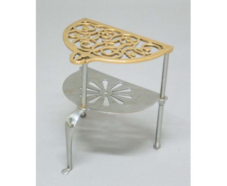REGENCY STEEL AND BRASS FOOTMAN, early 19th century, with scrolling pierced brass top above a foliate pierced steel lower she
