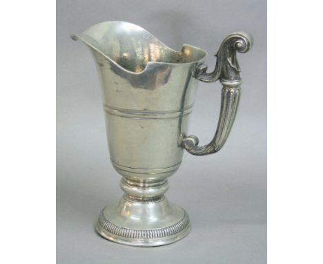 GEORGE III PEWTER EWER, early 19th century, of helmet form with scrolling handle and domed foot, height 26cm