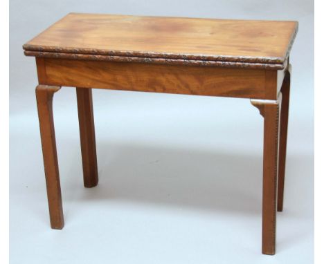 GEORGE III MAHOGANY FOLD OUT CARD TABLE, the rectangular top with floral carved rims above canted square section legs, concer