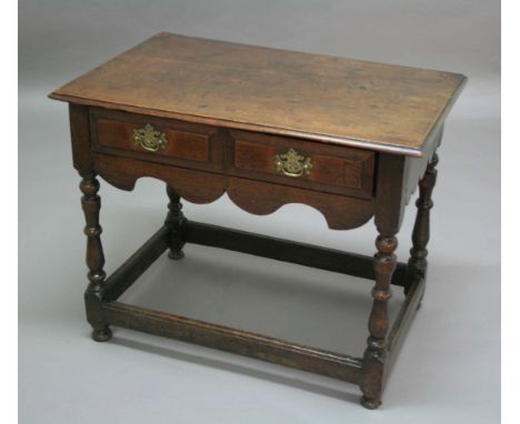 OAK SIDE TABLE, late 17th century, double fielded panel drawer above a wavy apron, block and turned legs and stretchers, heig