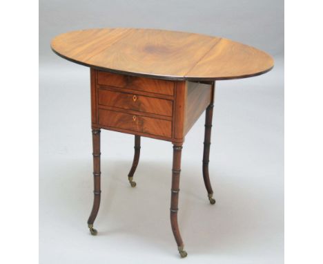 REGENCY MAHOGANY PEMBROKE STYLE WRITING TABLE, early 19th century, the oval top with a pair of drop leaves above a writing sl