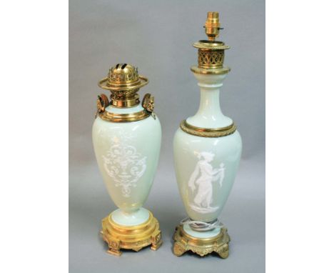 TWO FRENCH PORCELAIN AND GILT METAL MOUNTED TABLE LAMPS, with white pate sur pate style decoration of classical maidens on a 