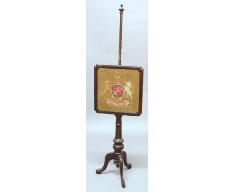 GEORGE III MAHOGANY POLE SCREEN, late 18th century and later, the cushion framed screen with Royal Crest Tapestry on a turned